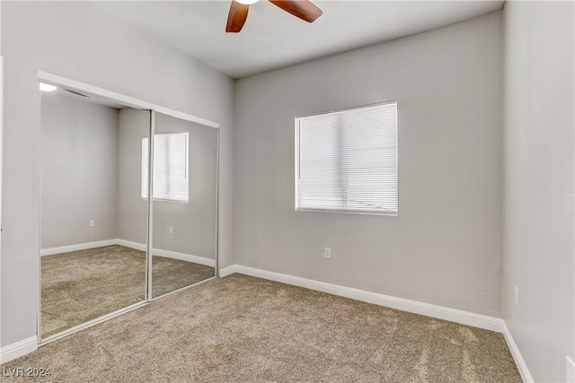 unfurnished bedroom with carpet flooring, a closet, and ceiling fan