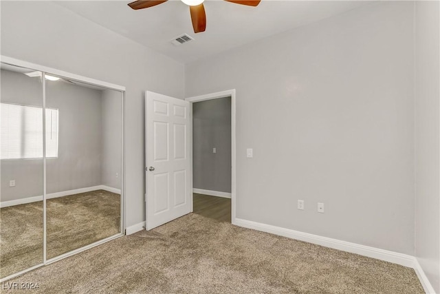 unfurnished bedroom with carpet, ceiling fan, and a closet