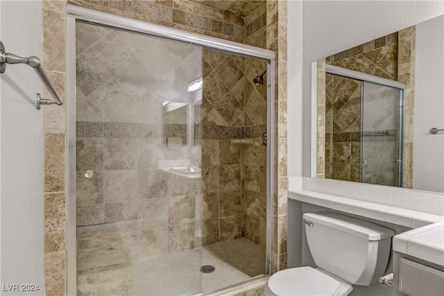 bathroom with toilet and a shower with door