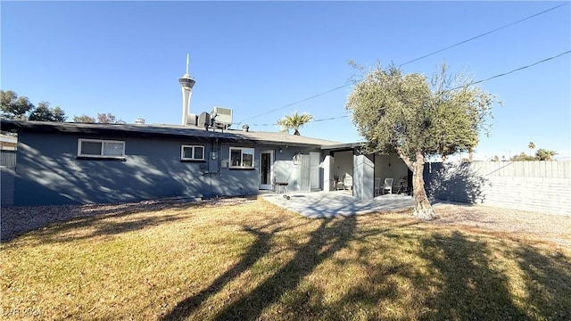 back of property with a lawn, a patio area, and central AC unit