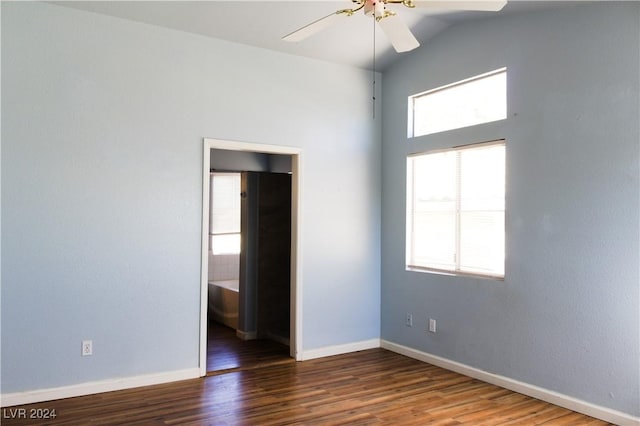 spare room with ceiling fan, dark hardwood / wood-style floors, and vaulted ceiling