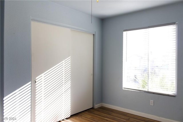 unfurnished room with dark wood-type flooring