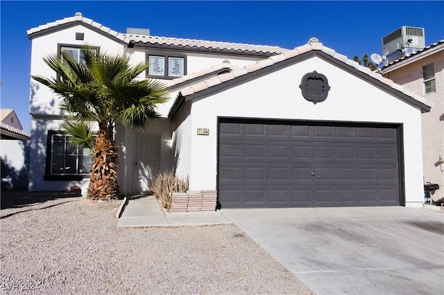 view of front of home featuring central air condition unit and a garage