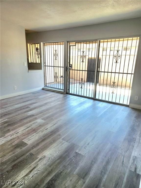 unfurnished room with hardwood / wood-style floors