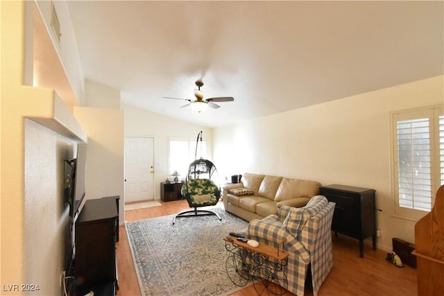 living room featuring wood-type flooring, ceiling fan, and lofted ceiling