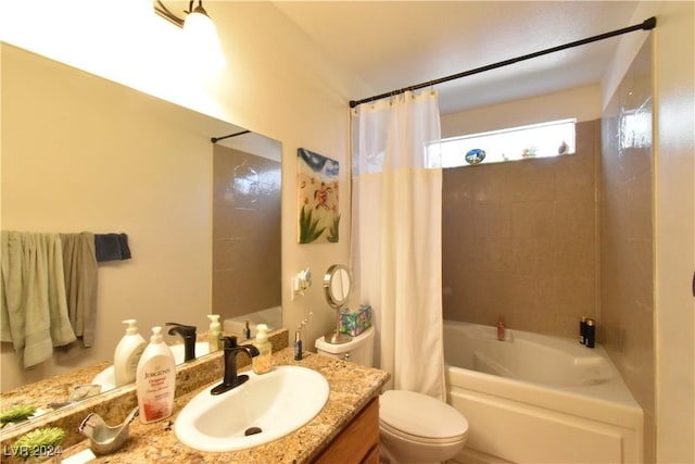 full bathroom with vanity, shower / tub combo, and toilet