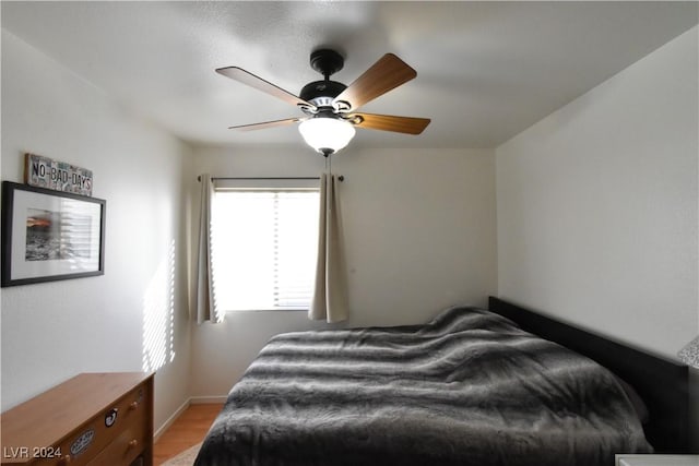 bedroom with ceiling fan and light hardwood / wood-style floors