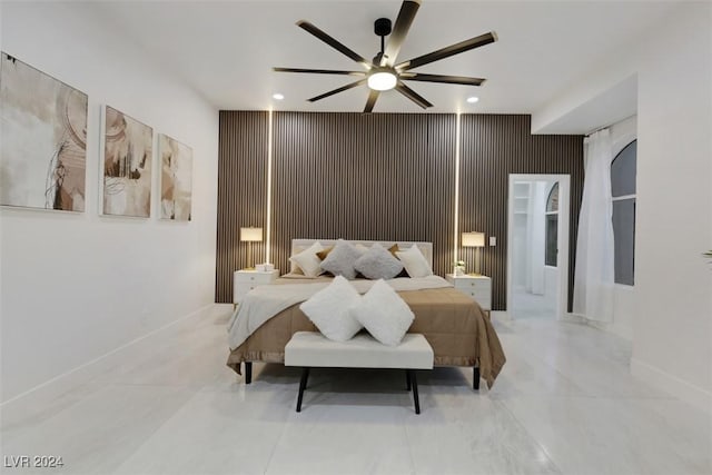 bedroom with ceiling fan and wooden walls