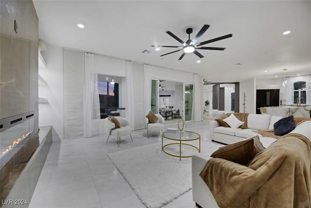 living room featuring a fireplace and ceiling fan