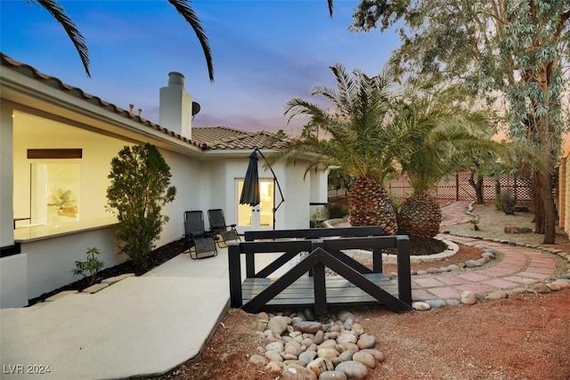 view of patio terrace at dusk