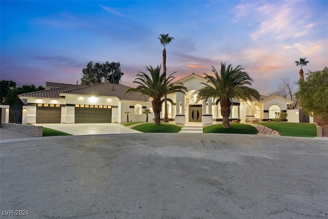 mediterranean / spanish home featuring a garage