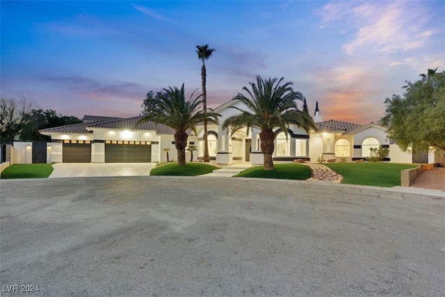 mediterranean / spanish-style house with a garage