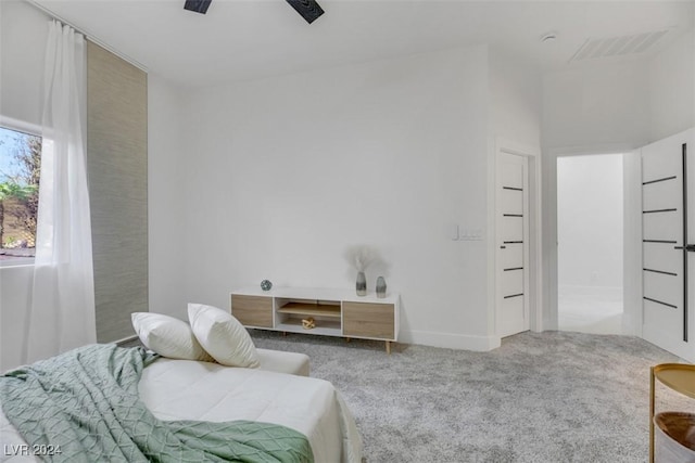 sitting room with carpet flooring and ceiling fan