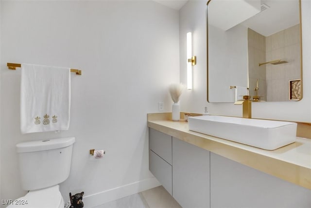 bathroom featuring tile patterned floors, vanity, and toilet