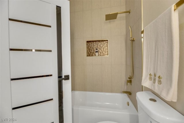 bathroom featuring tiled shower / bath combo and toilet