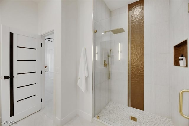 bathroom with tile patterned flooring and a shower with door