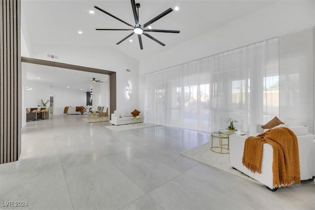 living room featuring vaulted ceiling and ceiling fan