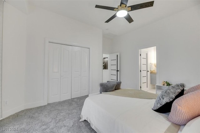 bedroom featuring carpet, a closet, ensuite bath, and ceiling fan