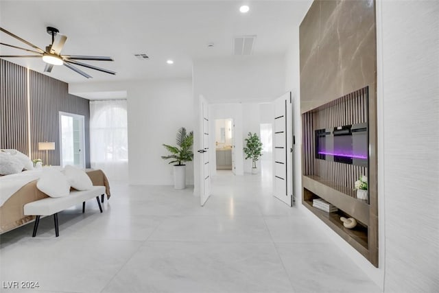 bedroom featuring ensuite bathroom and ceiling fan