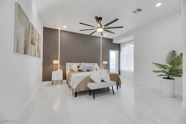 bedroom with wooden walls and ceiling fan