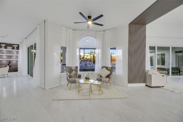 sitting room featuring ceiling fan and built in features