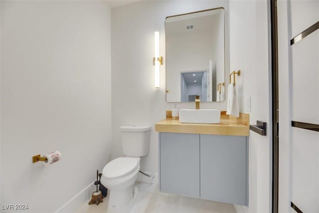 bathroom with tile patterned floors, vanity, and toilet