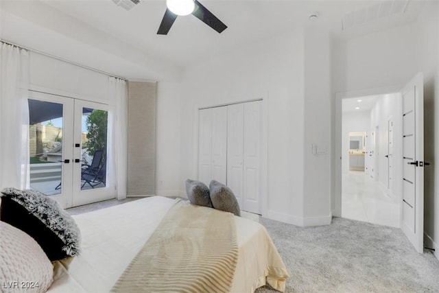 bedroom with access to exterior, ceiling fan, french doors, light colored carpet, and a closet