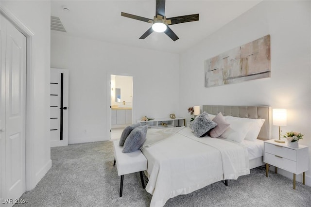 bedroom with ensuite bath, ceiling fan, and light carpet