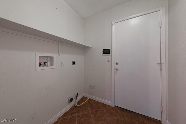 clothes washing area featuring hookup for a gas dryer, dark tile patterned floors, washer hookup, and hookup for an electric dryer