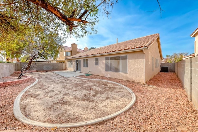 rear view of property with a patio and cooling unit