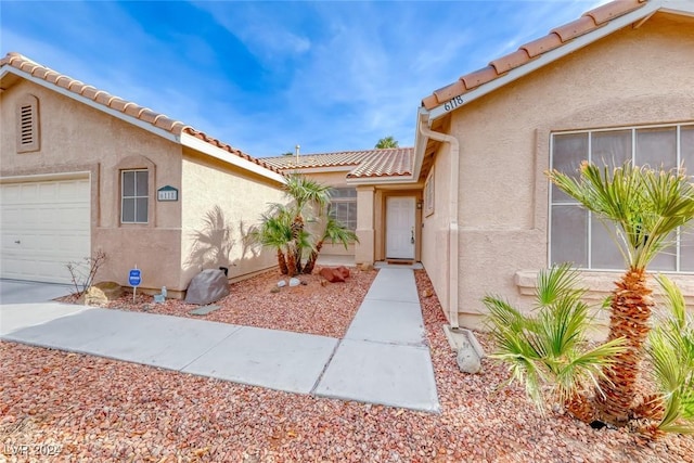 view of exterior entry featuring a garage