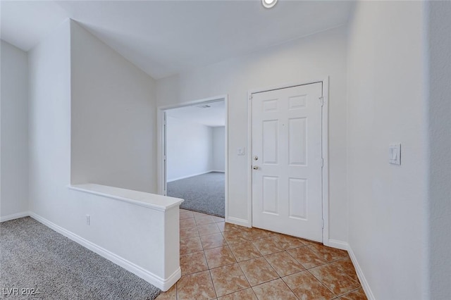 hall with light colored carpet