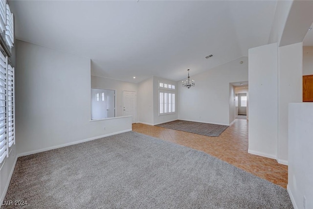 unfurnished living room with lofted ceiling, light tile patterned floors, and an inviting chandelier