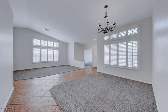 unfurnished living room featuring light tile patterned floors, a chandelier, and lofted ceiling