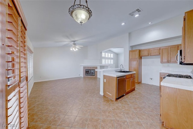 kitchen featuring appliances with stainless steel finishes, ceiling fan, sink, pendant lighting, and an island with sink