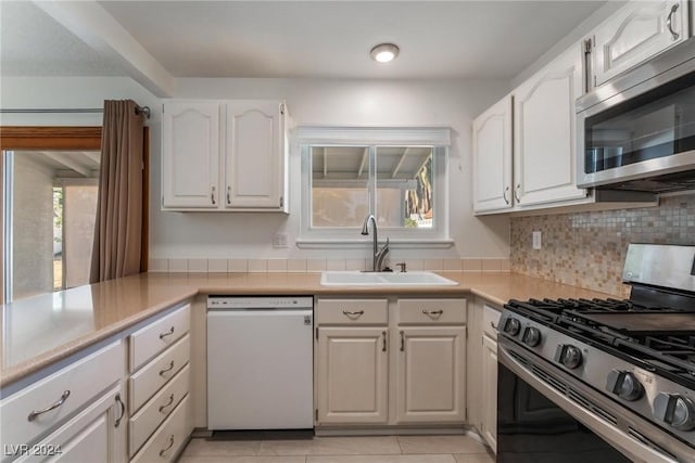 kitchen with white cabinets, stainless steel appliances, plenty of natural light, and sink