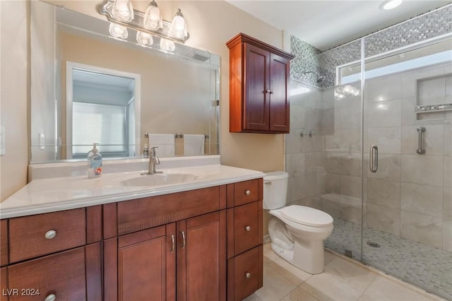 bathroom featuring walk in shower, vanity, tile patterned flooring, toilet, and plenty of natural light