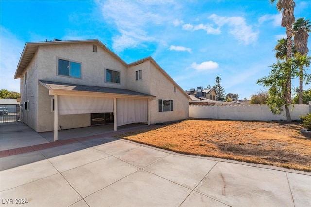 rear view of house with a patio and a garage