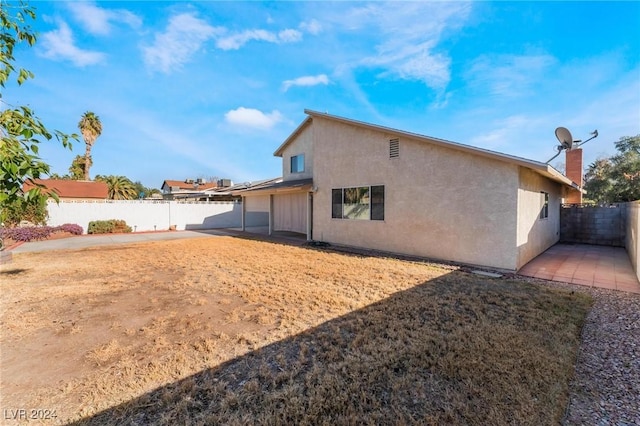 back of property featuring a patio area