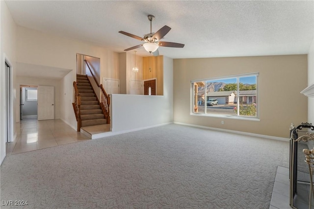 unfurnished living room with a textured ceiling, light colored carpet, ceiling fan, and lofted ceiling