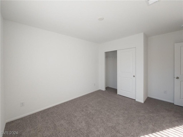 unfurnished bedroom with a closet and carpet floors