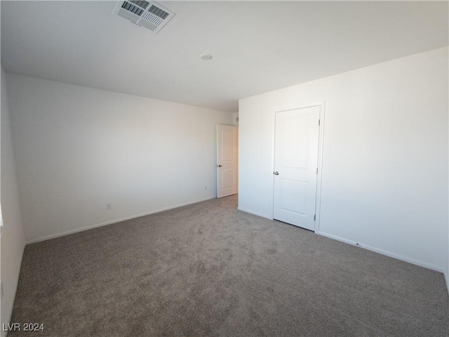 empty room featuring dark carpet