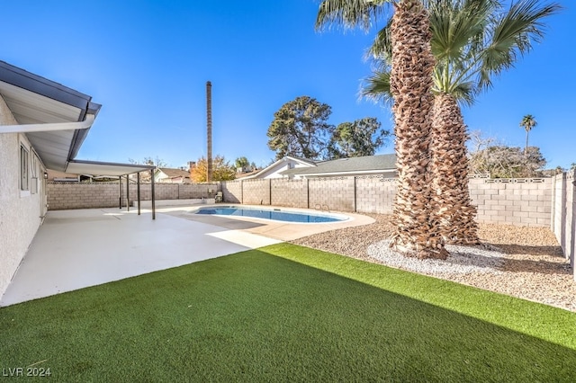 view of yard with a patio area and a fenced in pool