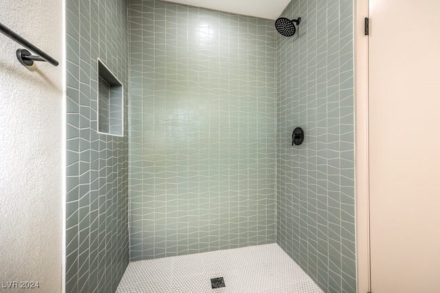 bathroom with tiled shower