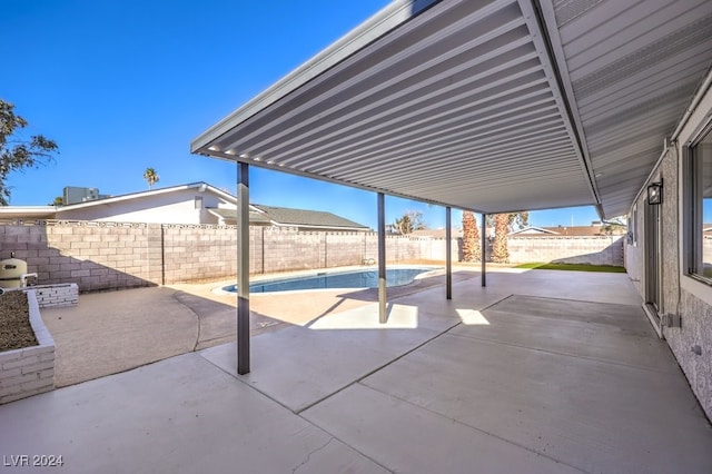 view of patio / terrace with a fenced in pool and central AC