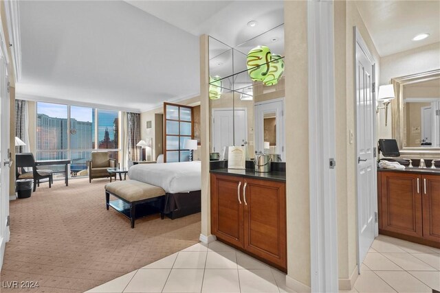 135 E Harmon Ave Unit 407, Las Vegas, NV 89109 - bedroom featuring light colored carpet, a sink, and light tile patterned floors