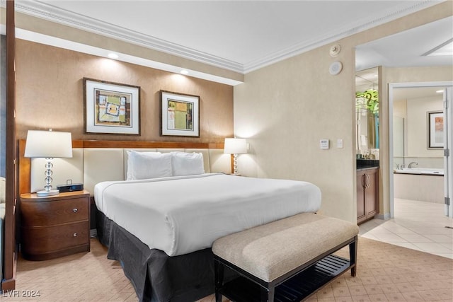 tiled bedroom featuring ornamental molding and ensuite bath