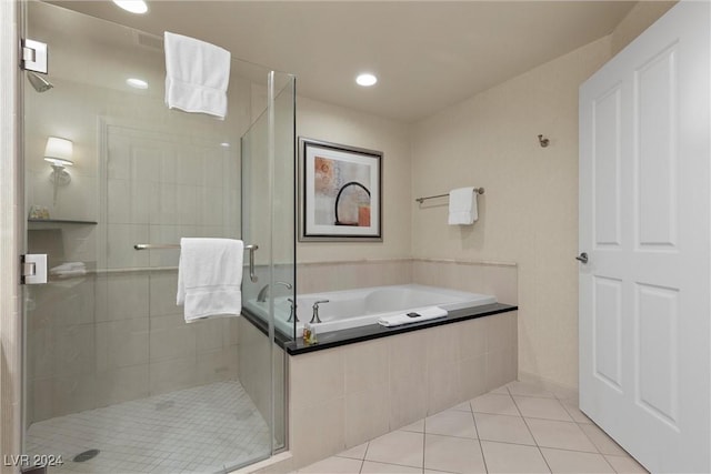 bathroom featuring tile patterned flooring and separate shower and tub