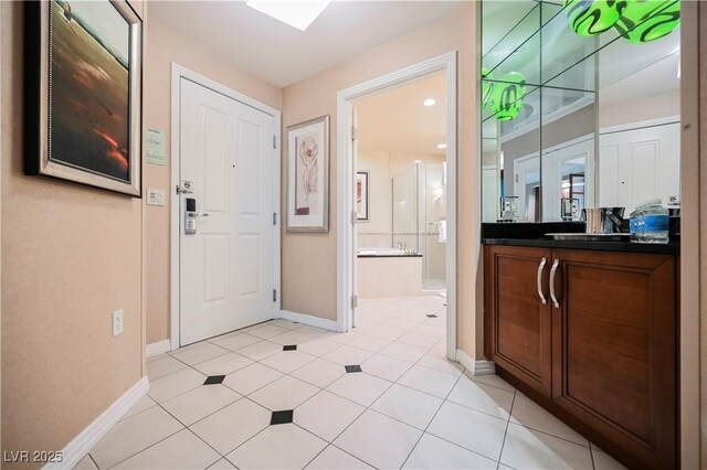 135 E Harmon Ave Unit 407, Las Vegas, NV 89109 - entryway featuring baseboards and light tile patterned floors