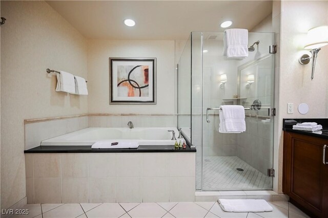 135 E Harmon Ave Unit 407, Las Vegas, NV 89109 - full bath with recessed lighting, a shower stall, tile patterned floors, vanity, and a garden tub